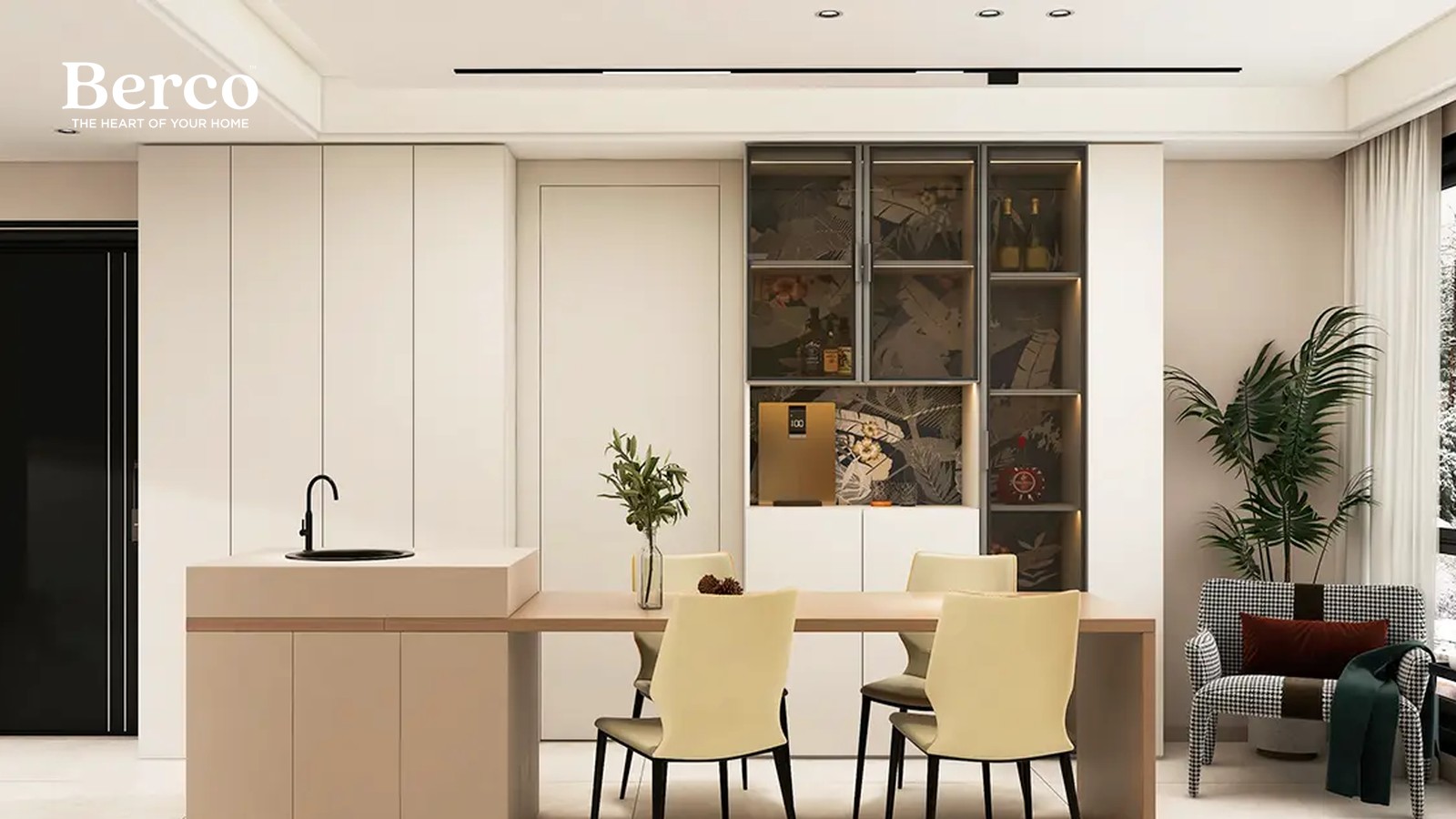 Dining table off a beige island beside a tall cream cabinet run with a lit glass-front section holding bottles and glassware — Berco design reference.