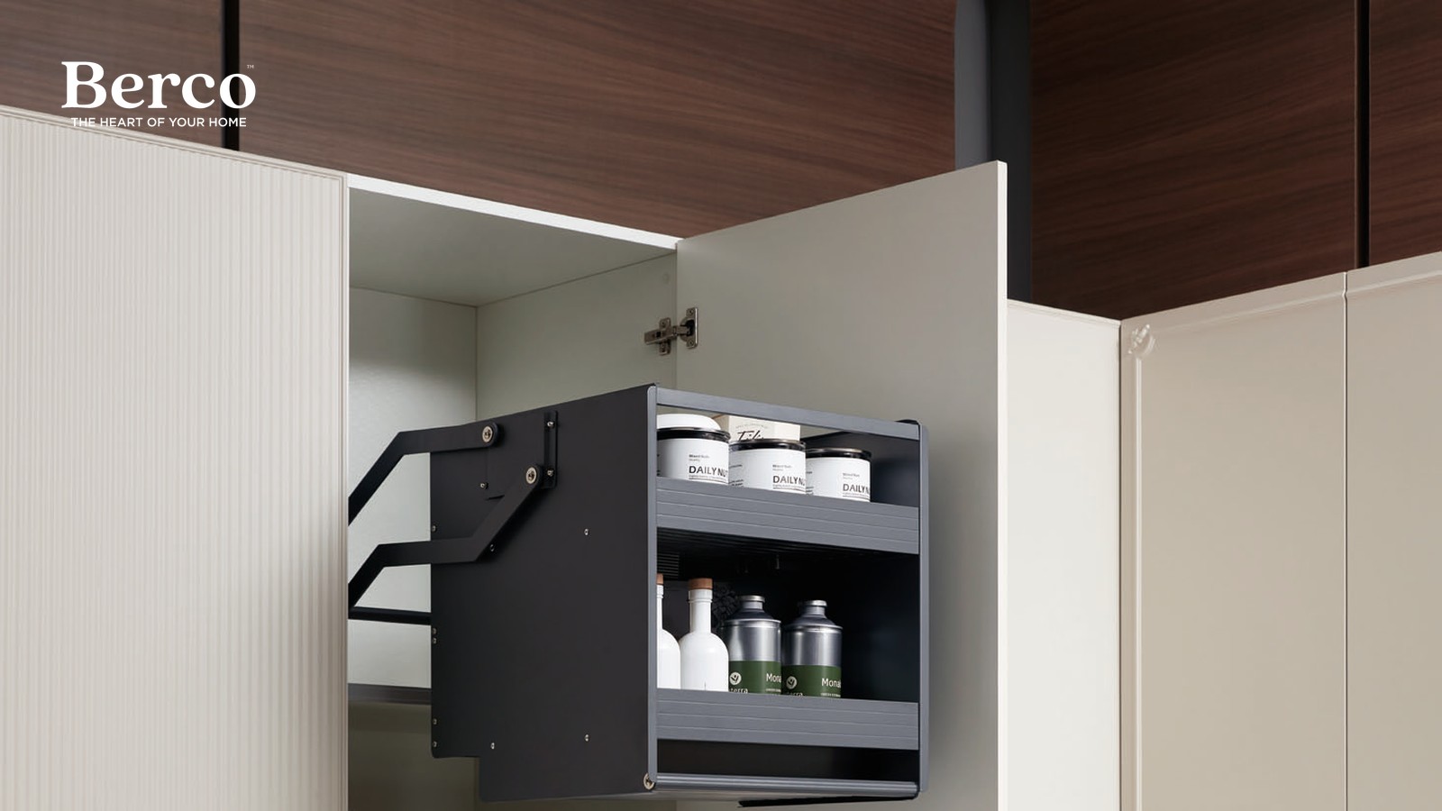 A two-tier basket swung down and forward out of a wall cabinet on a pivoting arm, holding jars and bottles — Berco design reference.