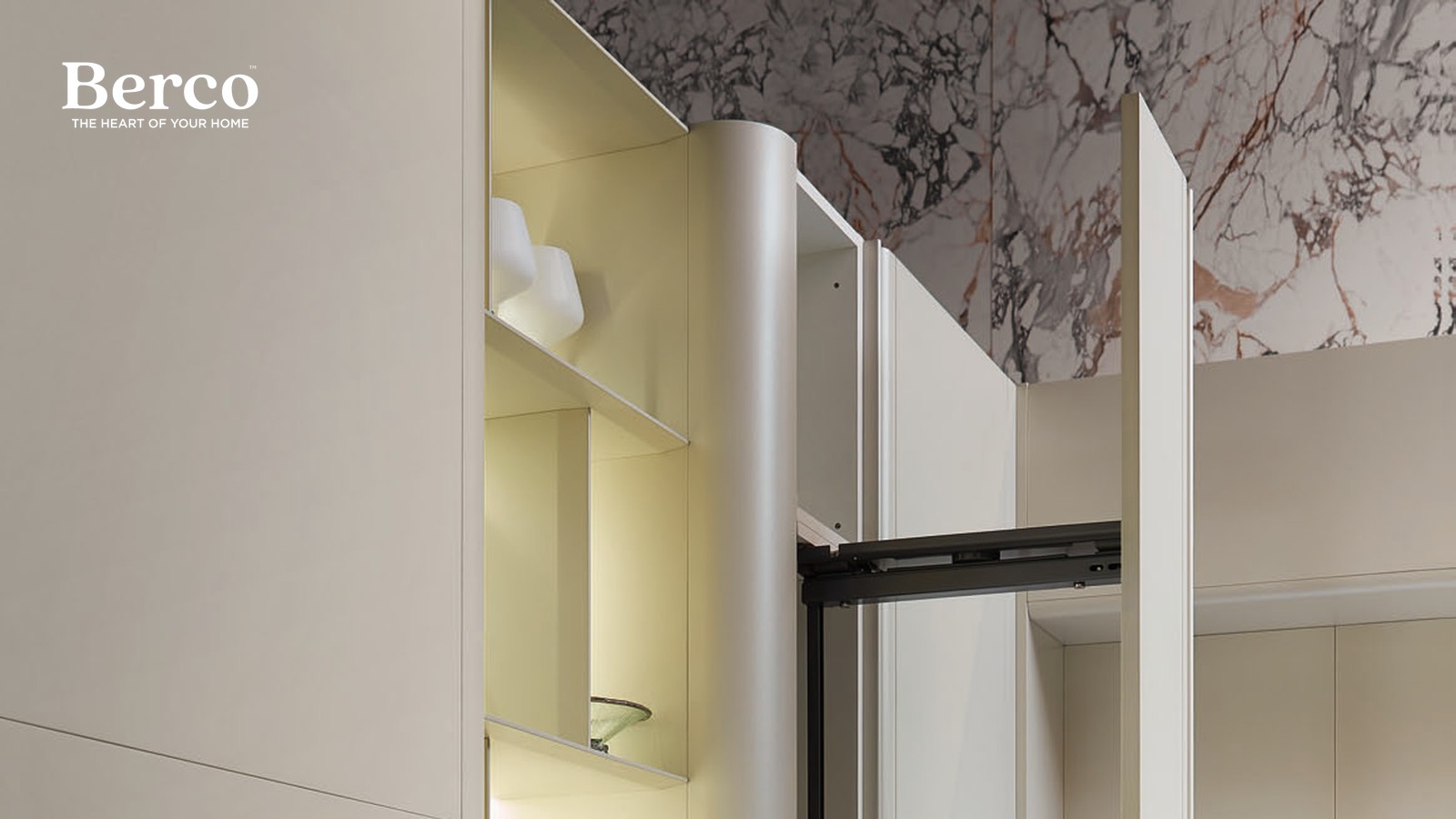 Full-height cream larder with backlit pull-out shelves beside a built-in oven — Berco design reference