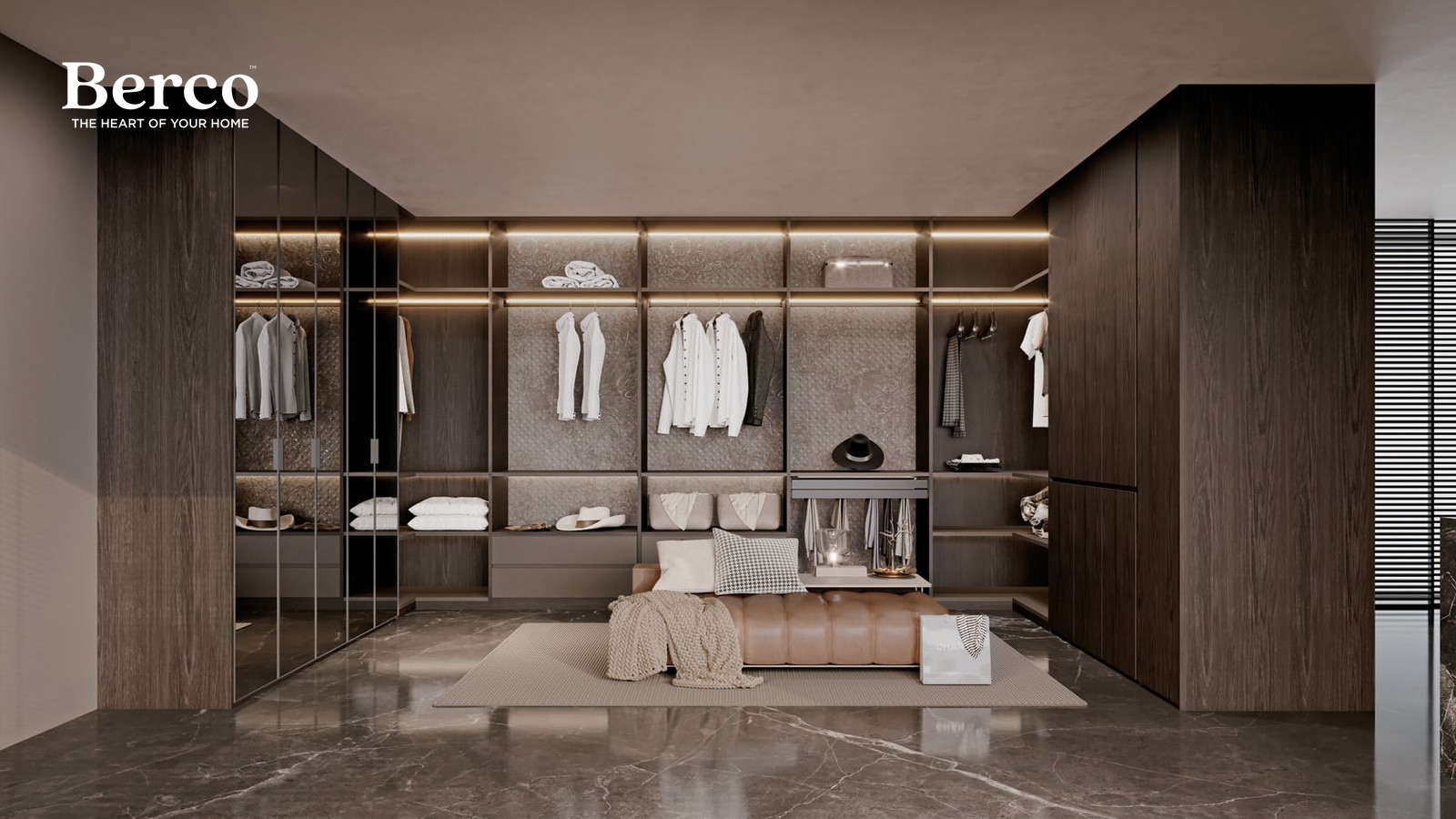 Warm oak walk-in dressing room with open hanging along one wall and a low drawer island at the centre — Berco design reference