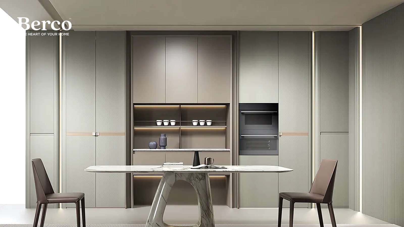 A dining and kitchen wall in soft sage cabinetry with pale wood open shelving and a built-in oven — Berco design reference.